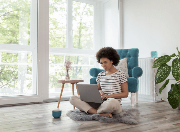 Woman using a computer in modern home