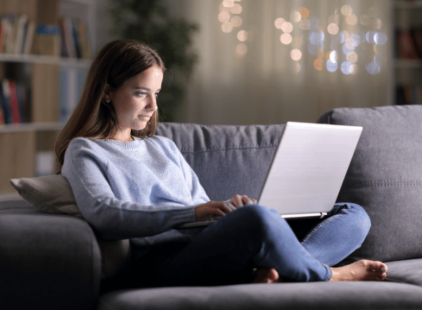 Woman Using Laptop for Internet Access